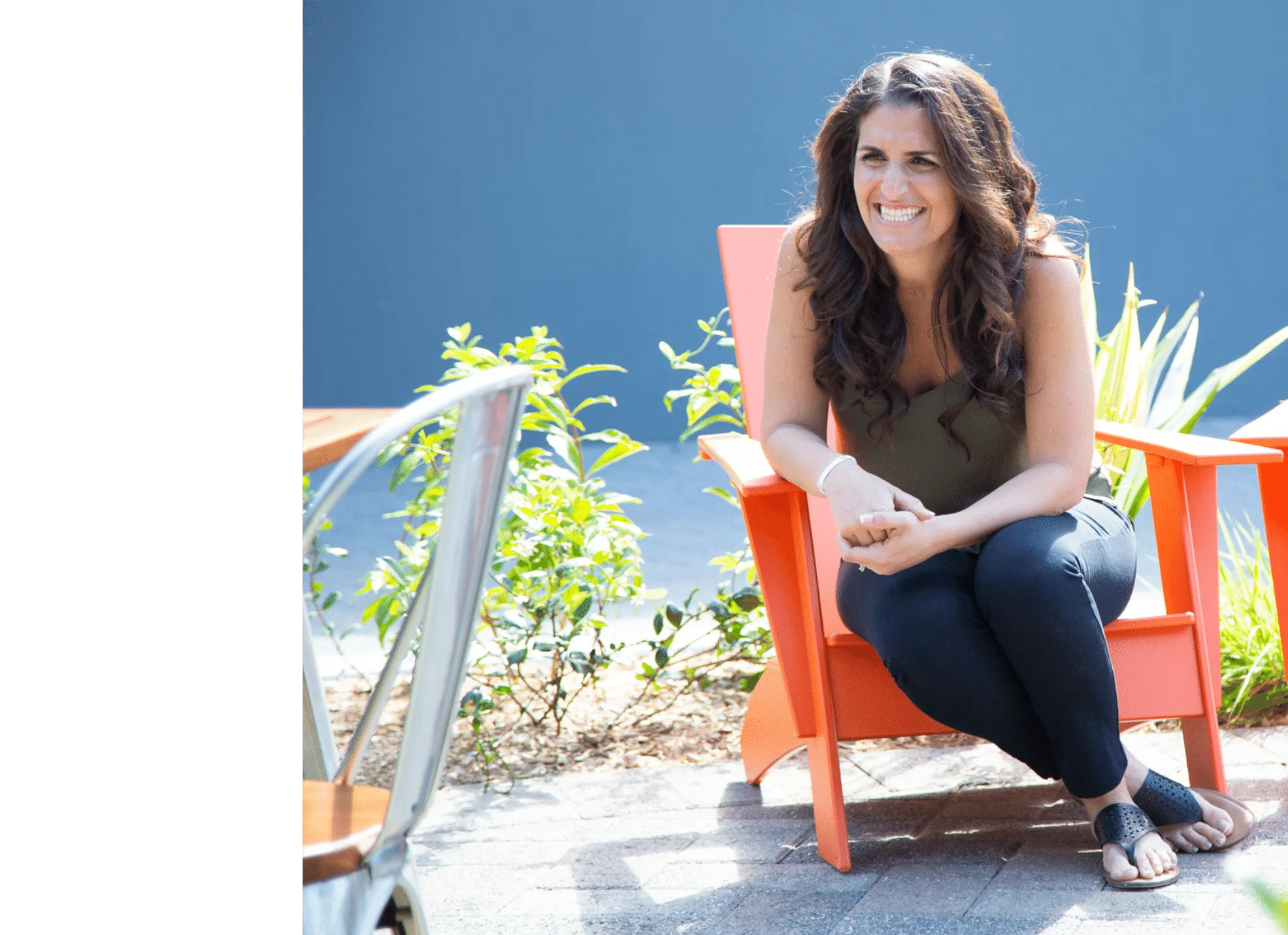 Katy Rey smiling while seated outside