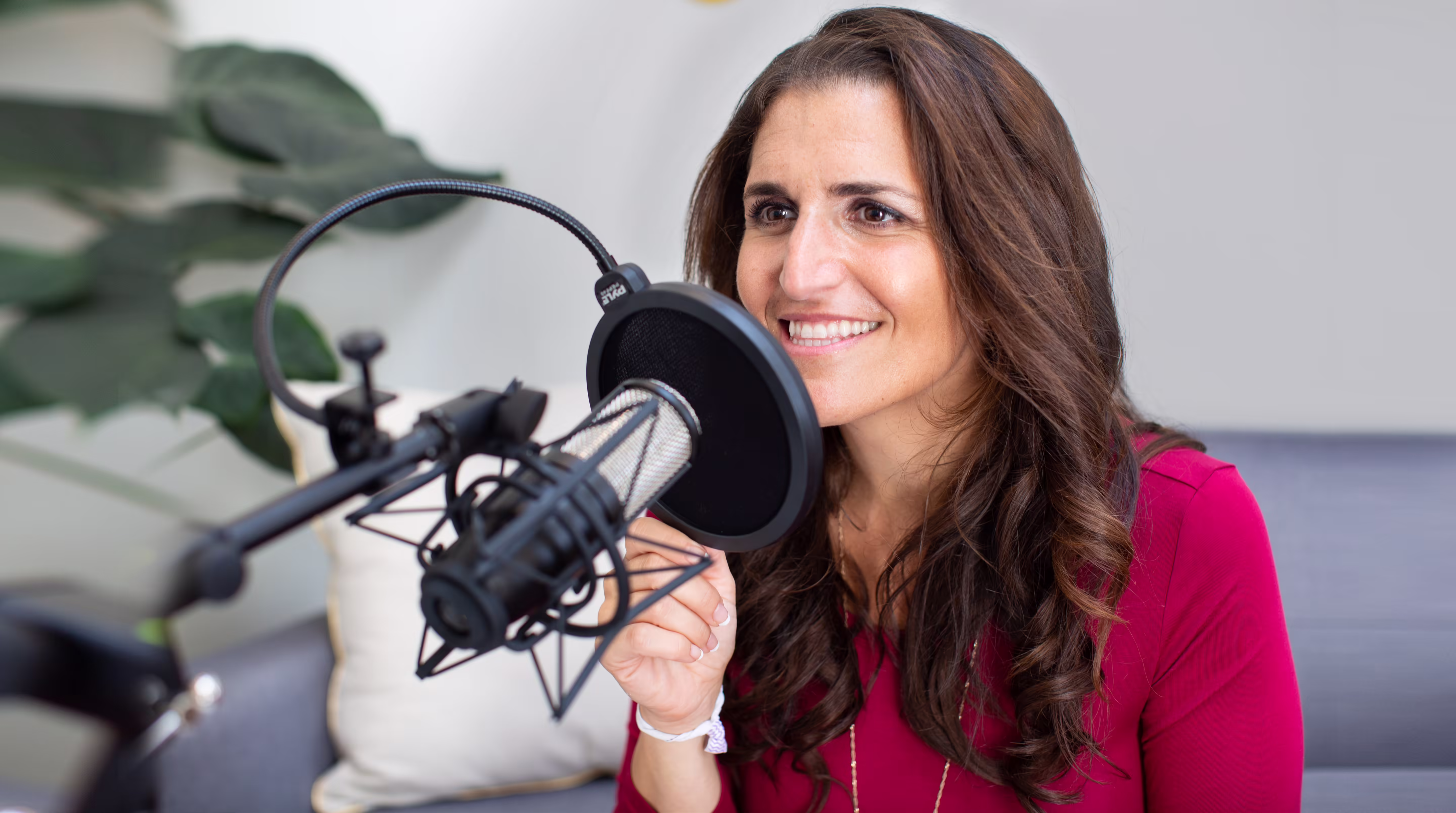 Katy Rey recording Not A Great Whisperer with a podcast microphone