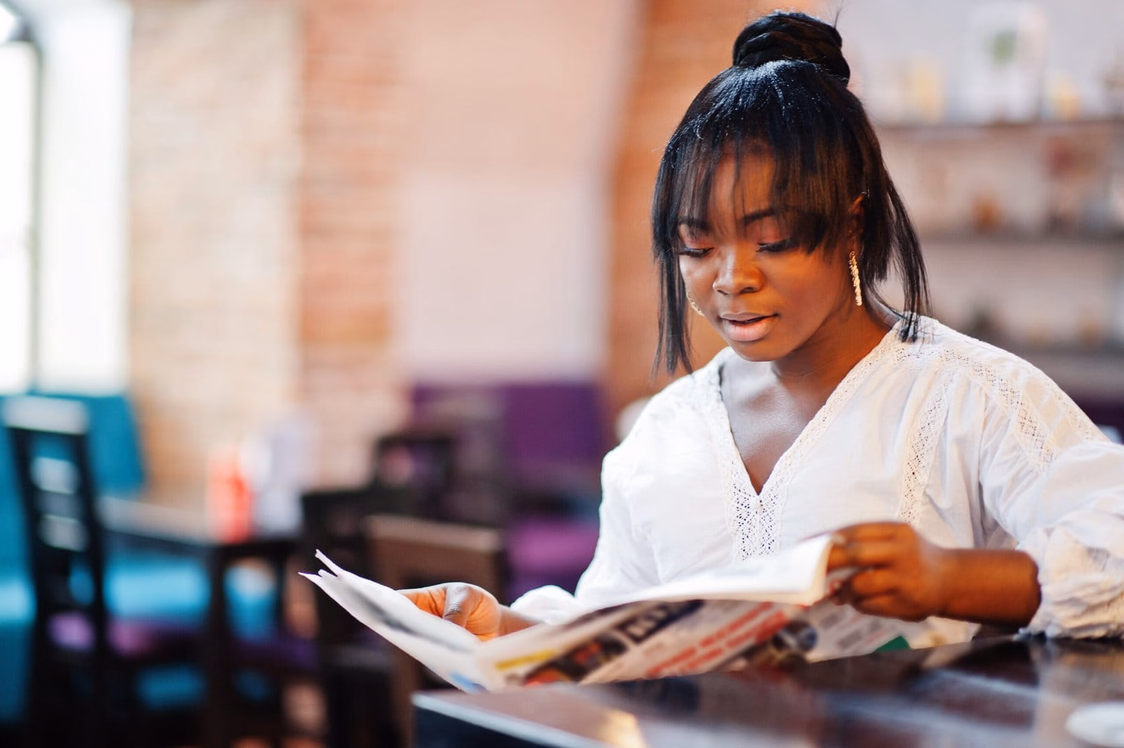 Young woman reading and working toward her next step
